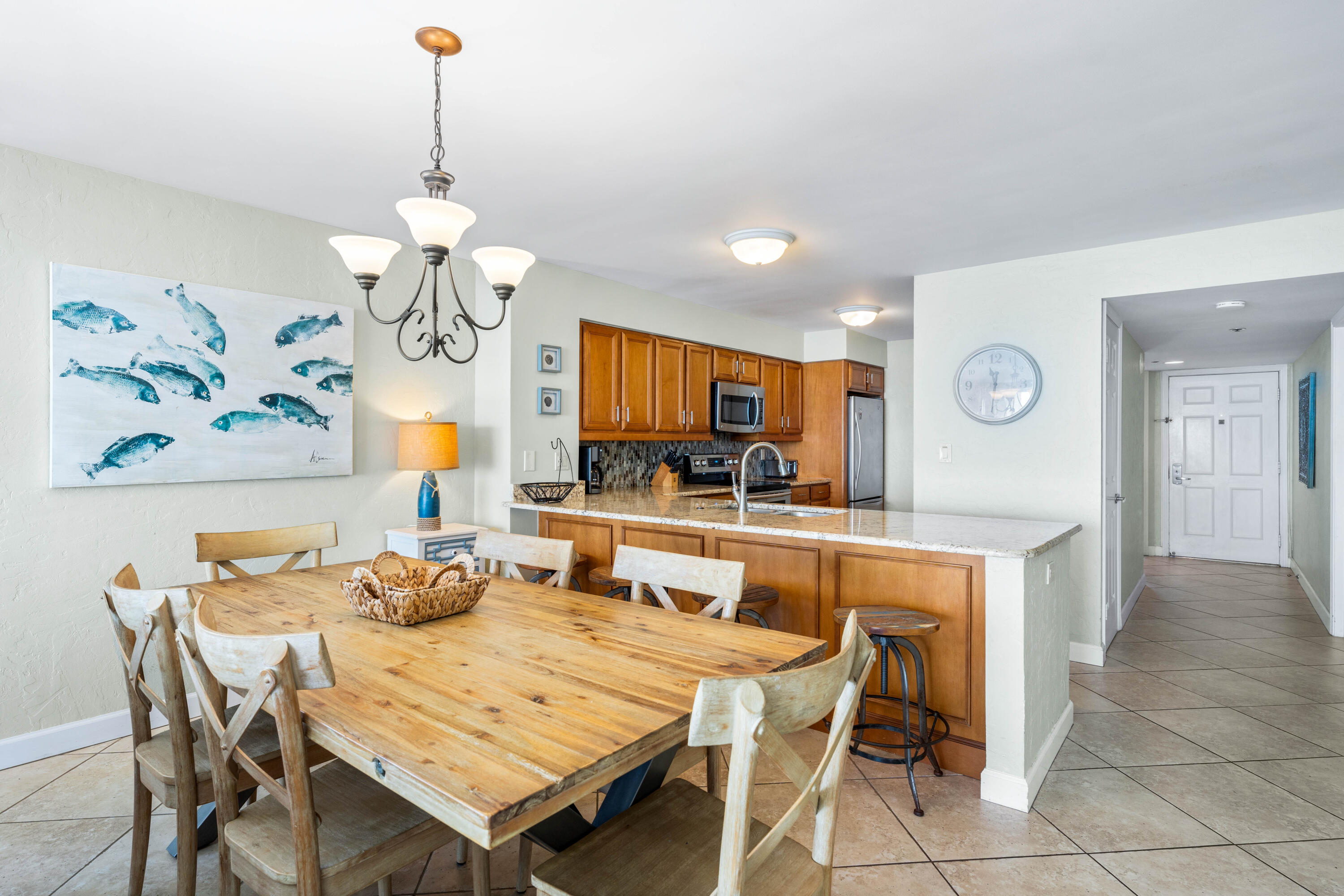 9815 Highway 98, Unit A1506 Miramar Beach, FL 32550 - Photo 4 of 44 a view of a dining room with furniture a chandelier and wooden floor