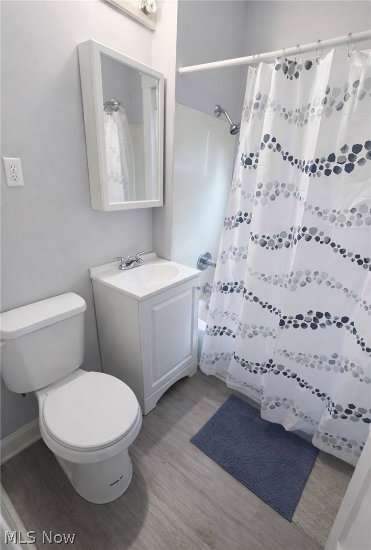 Bathroom featuring vanity, light wood-type flooring, and shower / tub combo