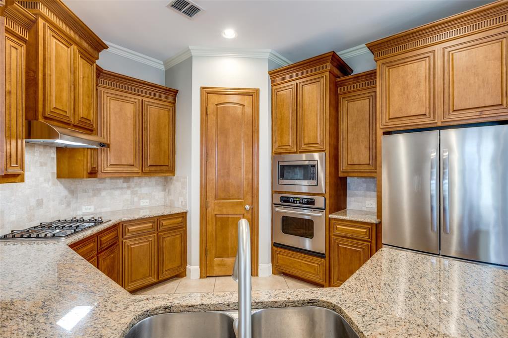 131 North Ridge Trail Prosper, TX 75078 - Photo 11 of 25 a kitchen with stainless steel appliances granite countertop a refrigerator and a sink