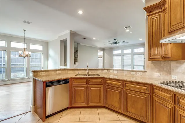 a kitchen that has a sink a stove and window