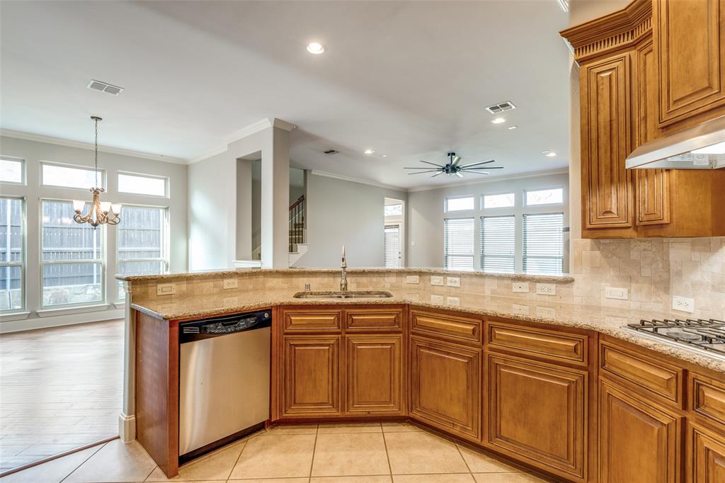 131 North Ridge Trail Prosper, TX 75078 - Photo 12 of 25 a kitchen that has a sink a stove and window