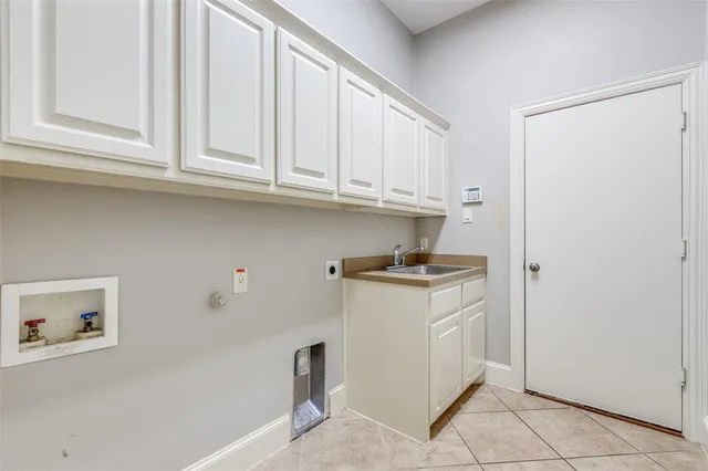 a kitchen with stainless steel appliances granite countertop a sink and a refrigerator