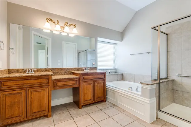 a bathroom with a tub sink and mirror