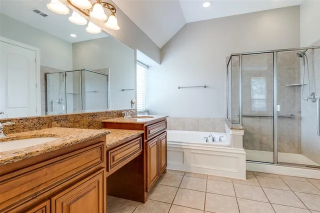 a bathroom with a granite countertop sink a toilet and shower