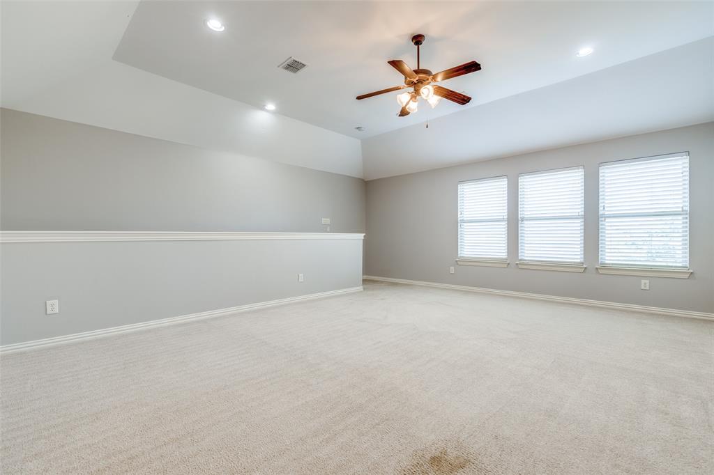 131 North Ridge Trail Prosper, TX 75078 - Photo 23 of 25 an empty room with ceiling fan and windows