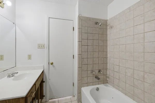 a bathroom with a bathtub shower sink and toilet