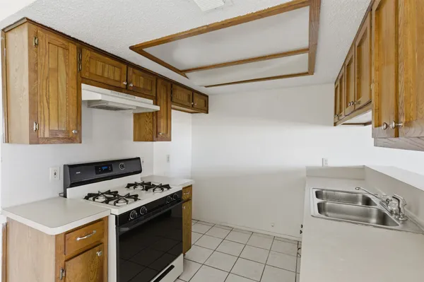 a kitchen with a stove and a sink