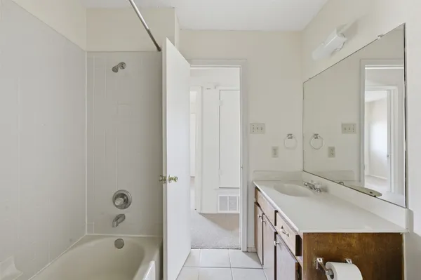a bathroom with a sink a mirror and a bathtub