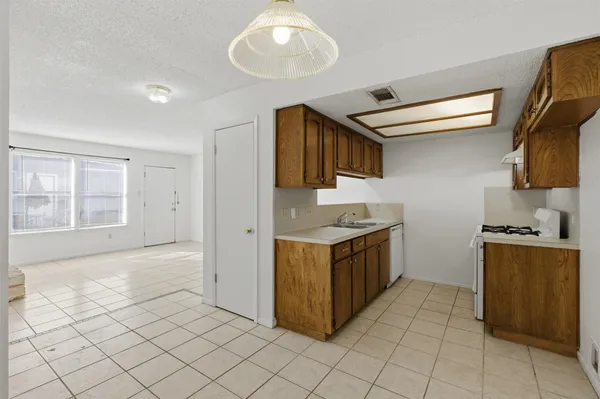 a kitchen with stainless steel appliances granite countertop a sink and a stove