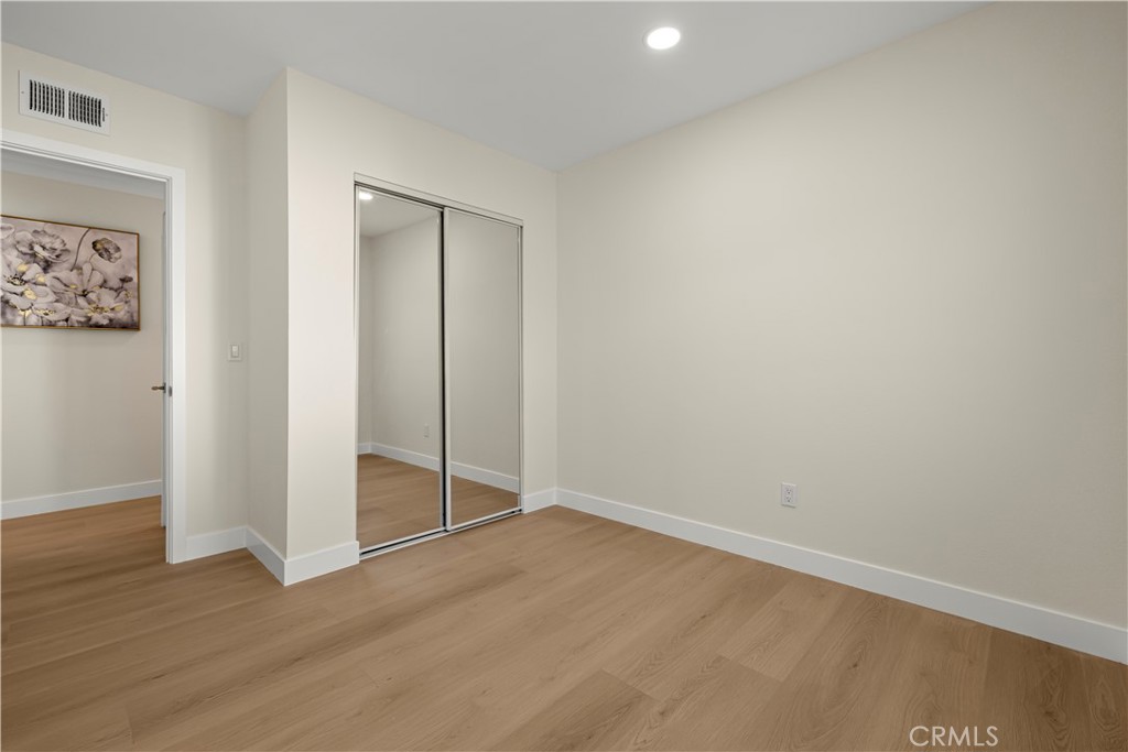 16931 Rinaldi Street Granada Hills, CA 91344 - Photo 24 of 46 an empty room with wooden floor and closet