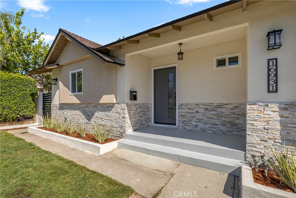 16931 Rinaldi Street Granada Hills, CA 91344 - Photo 5 of 46 a front view of a house with garage