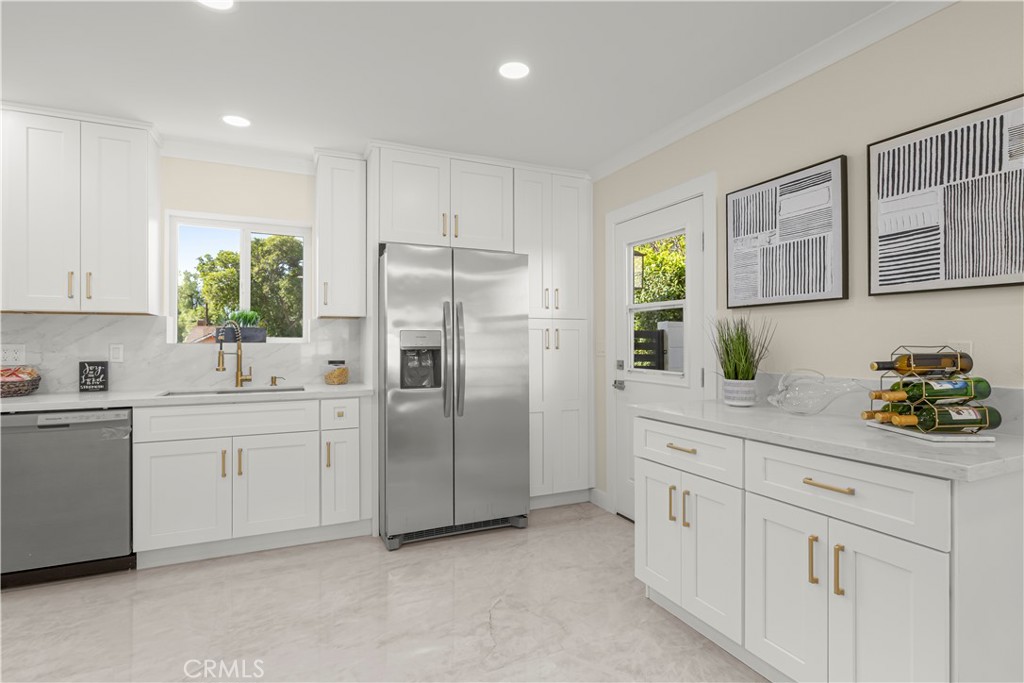 16931 Rinaldi Street Granada Hills, CA 91344 - Photo 8 of 46 a kitchen with white cabinets and refrigerator