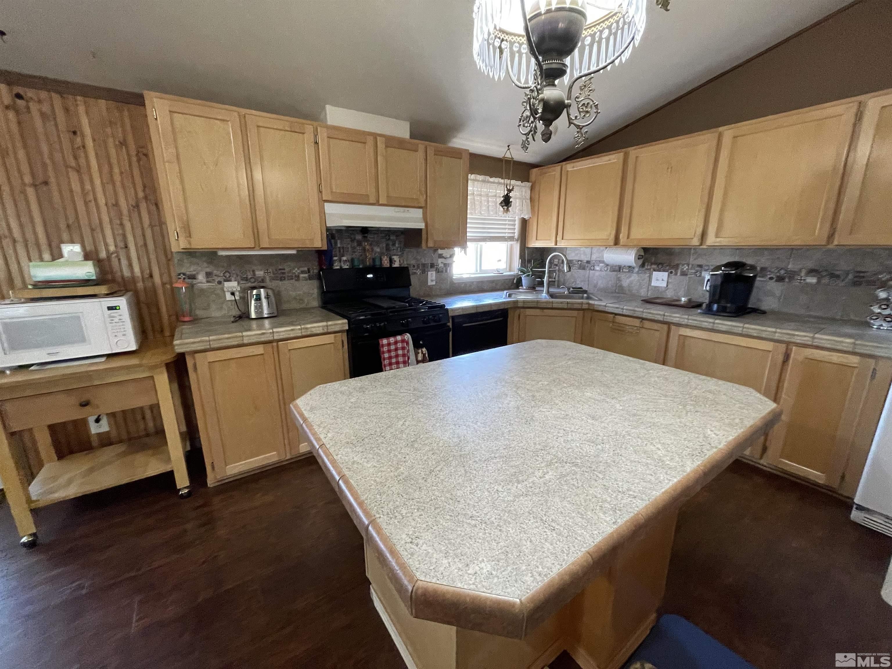 4045 Grouse Way Reno, NV 89508 - Photo 20 of 22 a kitchen with granite countertop a sink a counter top space appliances and cabinets