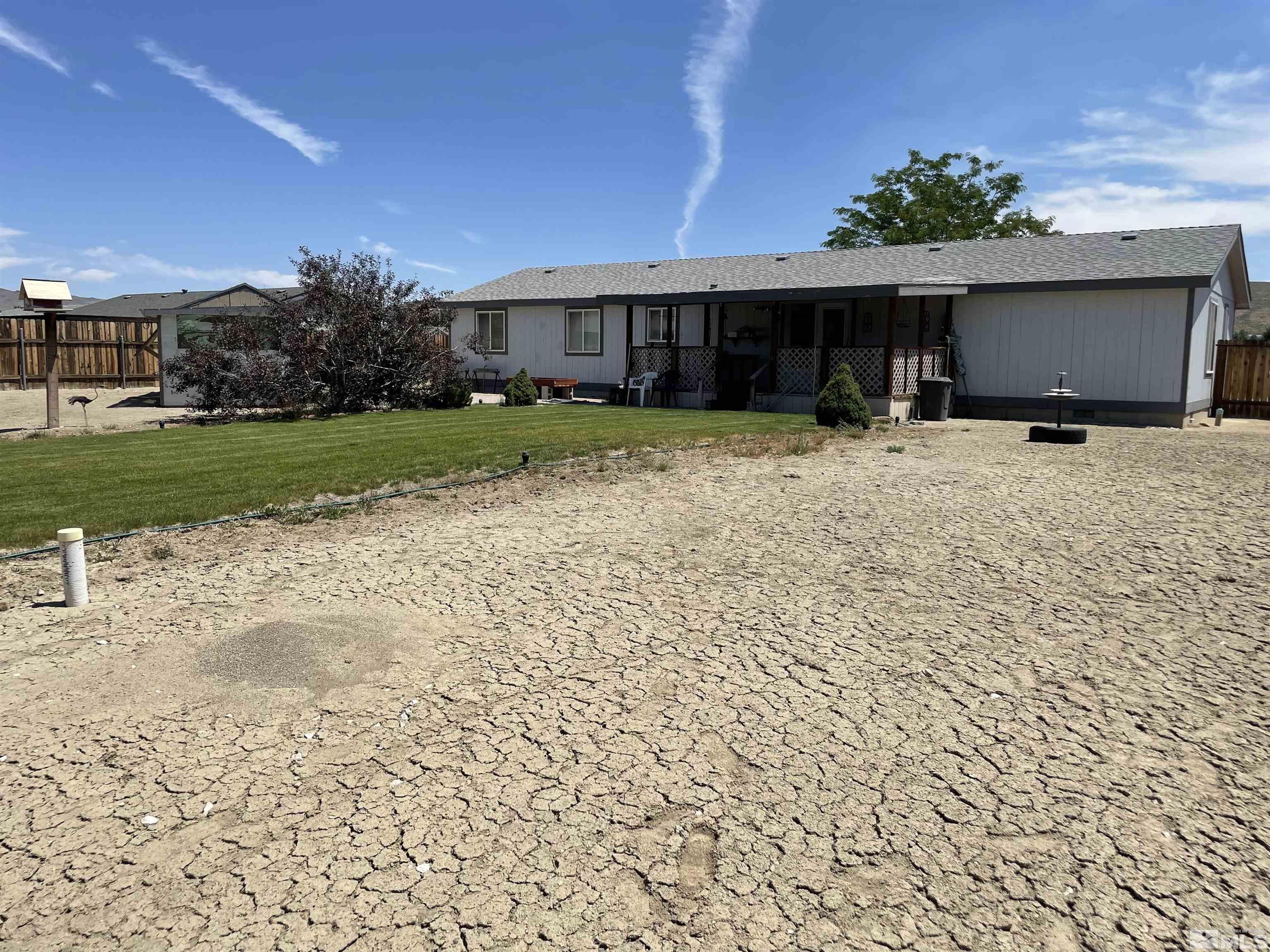 4045 Grouse Way Reno, NV 89508 - Photo 2 of 22 a front view of a house with a yard