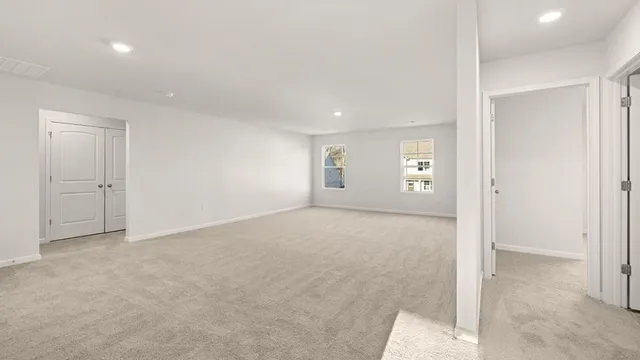 an empty room with windows and closet