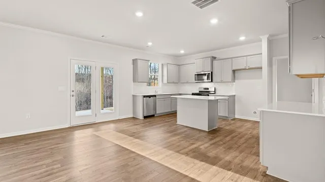 a kitchen with stainless steel appliances granite countertop a stove a sink and a refrigerator