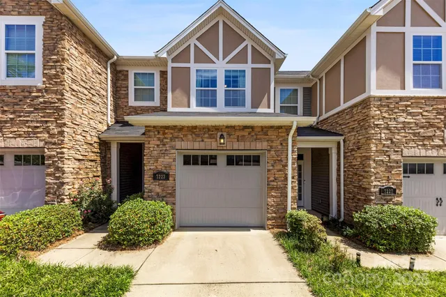 a kitchen with kitchen island granite countertop a sink stove and refrigerator