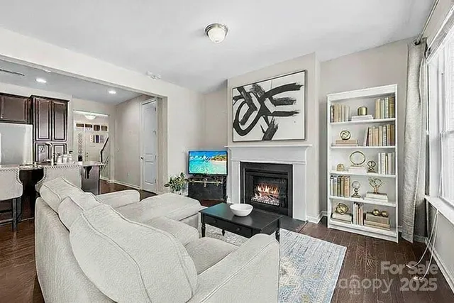 a kitchen with kitchen island a stove a sink a refrigerator and cabinets