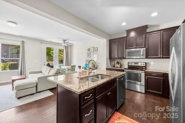 a bathroom with a granite countertop toilet a sink and shower