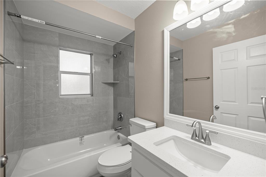 46 Teak Run Ocala, FL 34472 - Photo 17 of 26 a bathroom with a bathtub shower sink vanity mirror and toilet