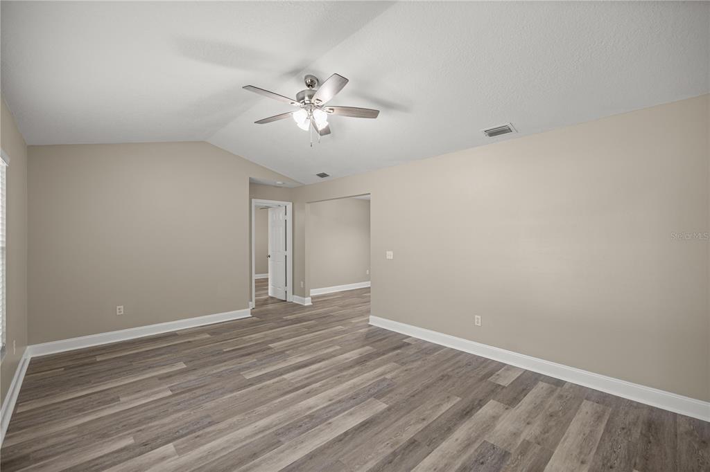 46 Teak Run Ocala, FL 34472 - Photo 5 of 26 a view of an empty room with chandelier fan and wooden floor
