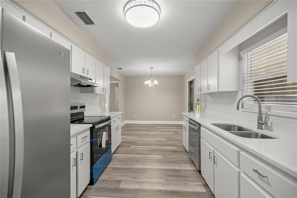 46 Teak Run Ocala, FL 34472 - Photo 7 of 26 a kitchen with granite countertop a sink and steel appliances