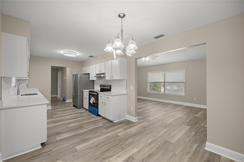 46 Teak Run Ocala, FL 34472 - Photo 9 of 26 a view of a kitchen with a sink a refrigerator and a stove top oven