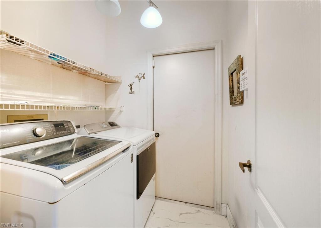 209 Countryside Drive Naples, FL 34104 - Photo 27 of 50 Laundry area with light marble finish flooring and separate washer and dryer