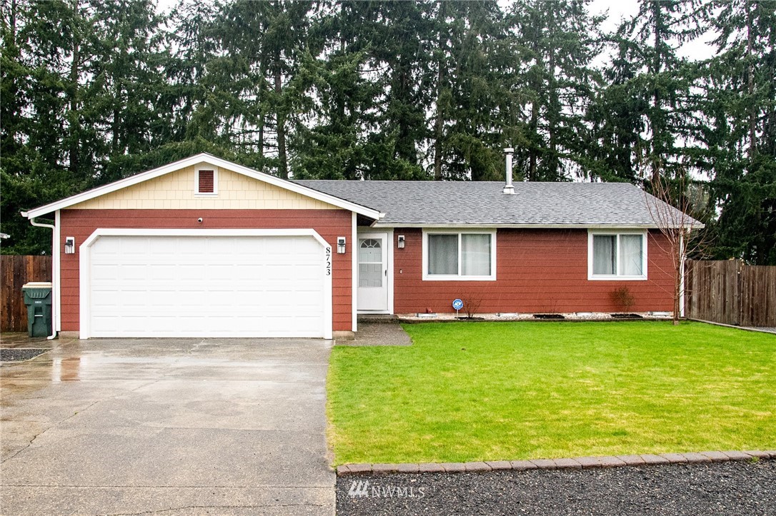 8723 Hawks Glen Loop Southeast Olympia, WA 98513 - Photo 12 of 12 a front view of a house with a yard and garage