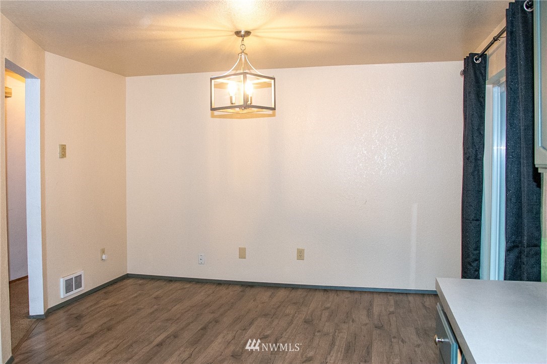 8723 Hawks Glen Loop Southeast Olympia, WA 98513 - Photo 3 of 12 a view of a room with wooden floor and chandelier