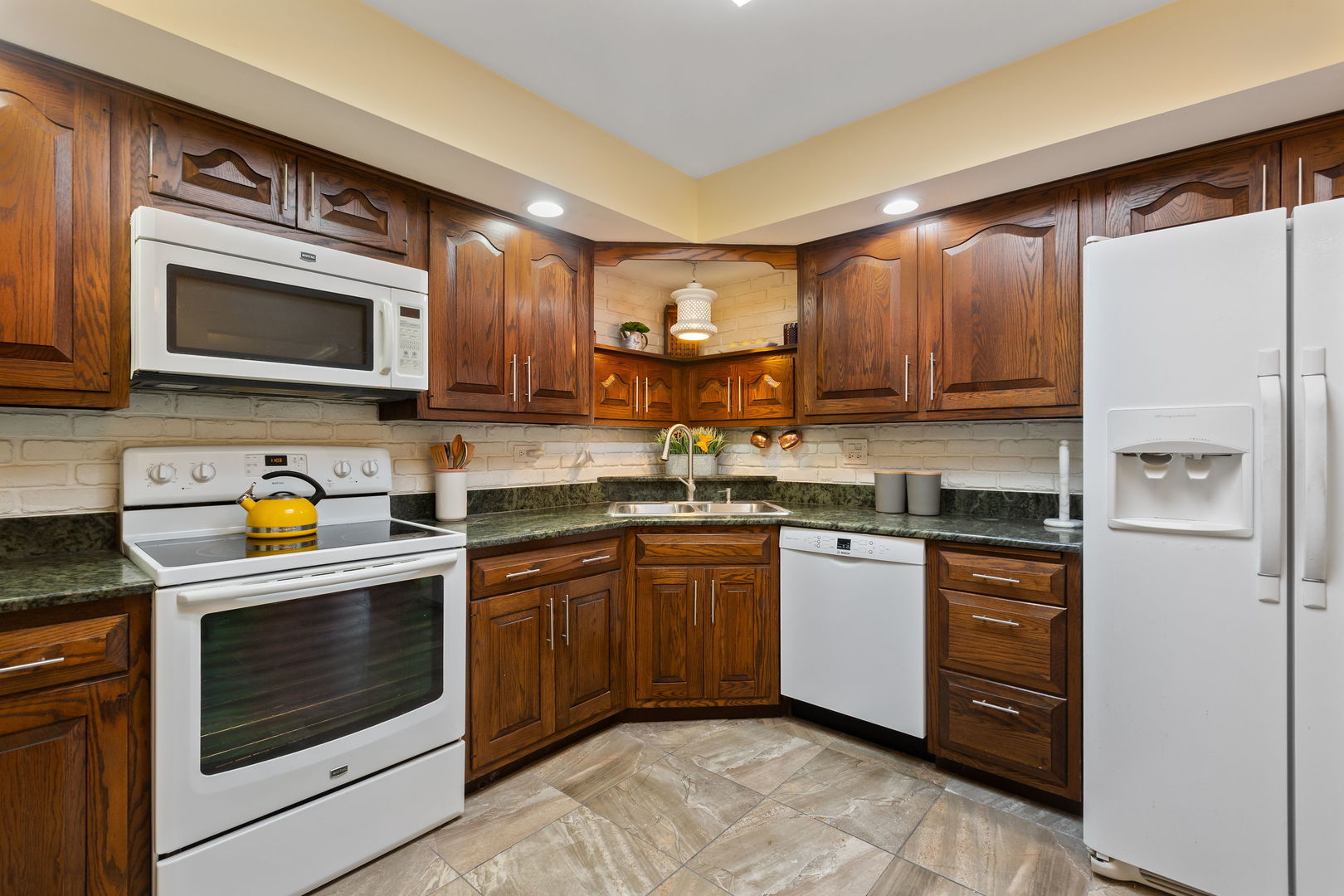 2425 El Cid Lane Northbrook, IL 60062 - Photo 13 of 28 a kitchen with stainless steel appliances granite countertop a stove microwave and refrigerator