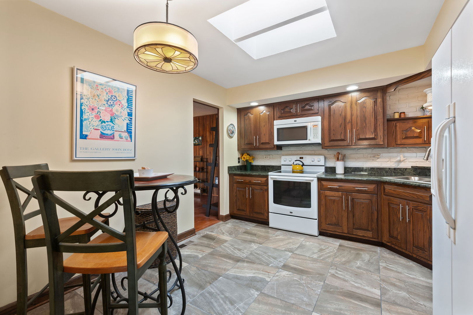 2425 El Cid Lane Northbrook, IL 60062 - Photo 15 of 28 a kitchen with stainless steel appliances granite countertop a stove top oven a sink a dining table and chairs