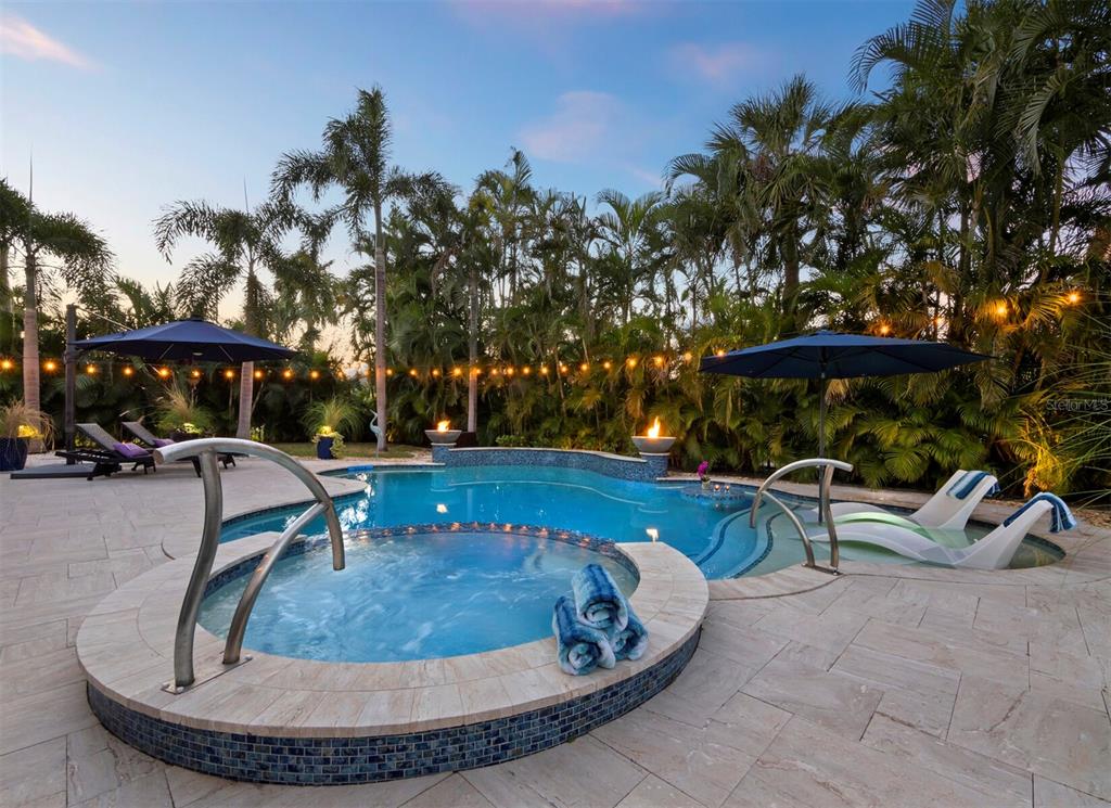 651 Broadway Street Longboat Key, FL 34228 - Photo 11 of 75 a view of a swimming pool with a patio and fire pit
