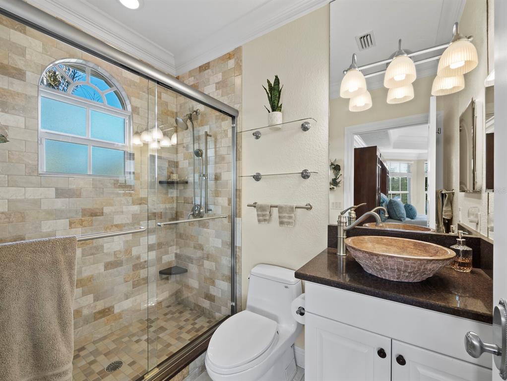 651 Broadway Street Longboat Key, FL 34228 - Photo 22 of 75 a bathroom with a sink a toilet and shower