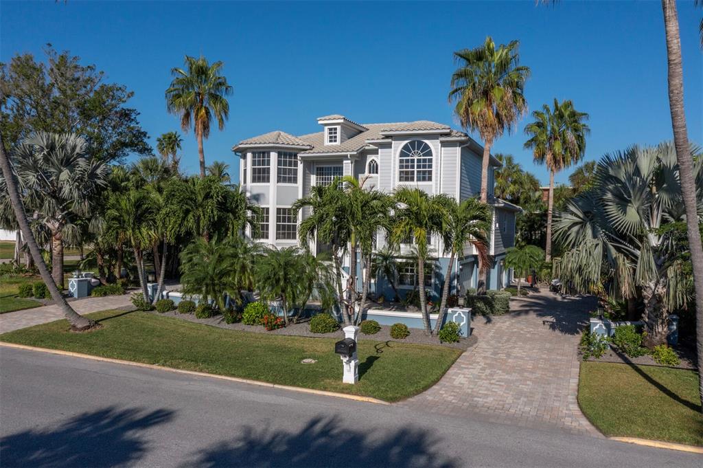 651 Broadway Street Longboat Key, FL 34228 - Photo 53 of 75 a front view of a house with a yard and tree