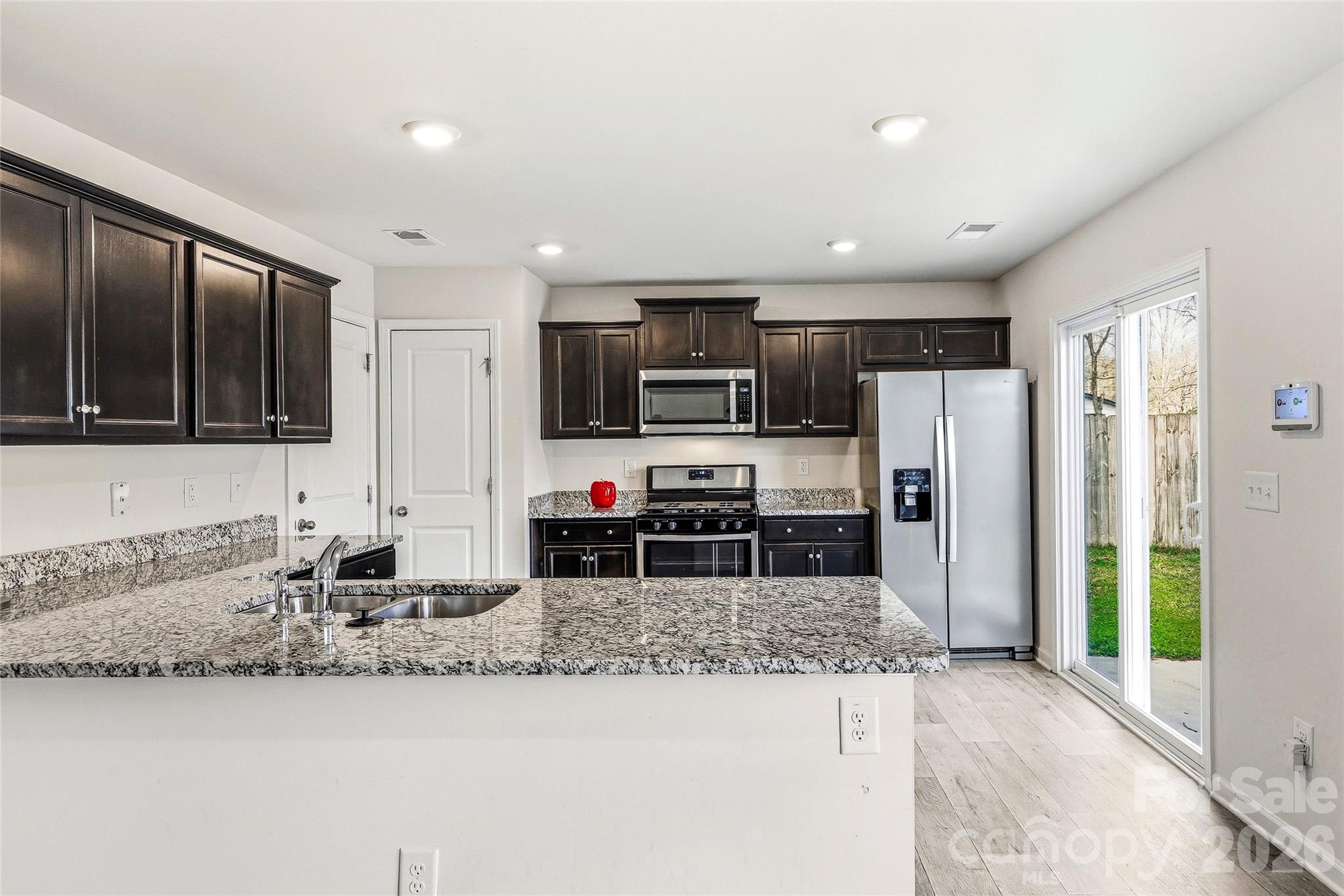 319 Oak Br Road Arden, NC 28704 - Photo 13 of 33 a kitchen with stainless steel appliances granite countertop a sink refrigerator and microwave