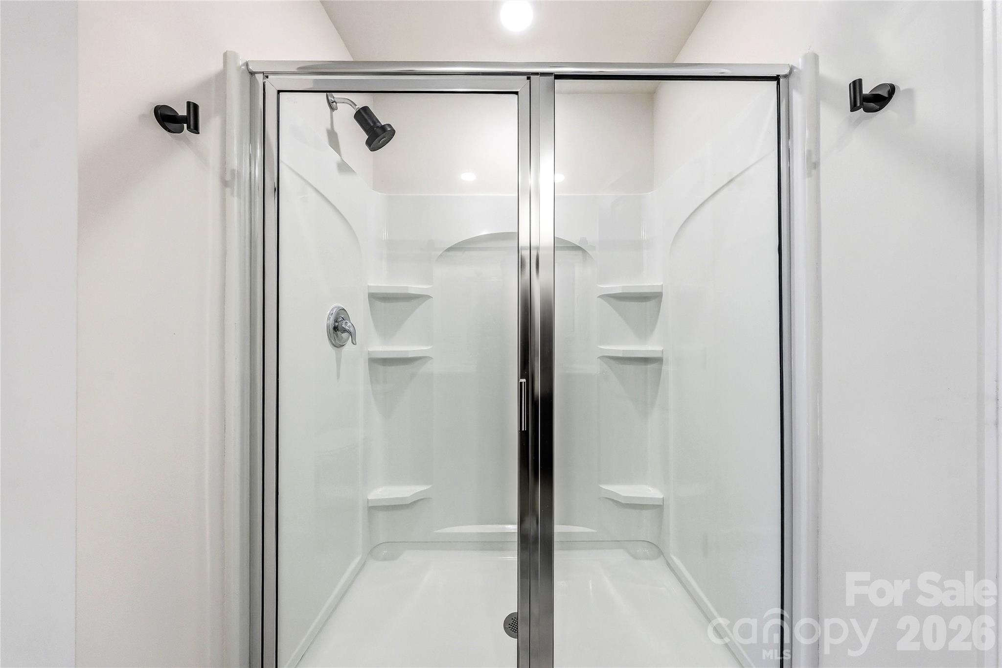 319 Oak Br Road Arden, NC 28704 - Photo 20 of 33 a bathroom with a glass shower door