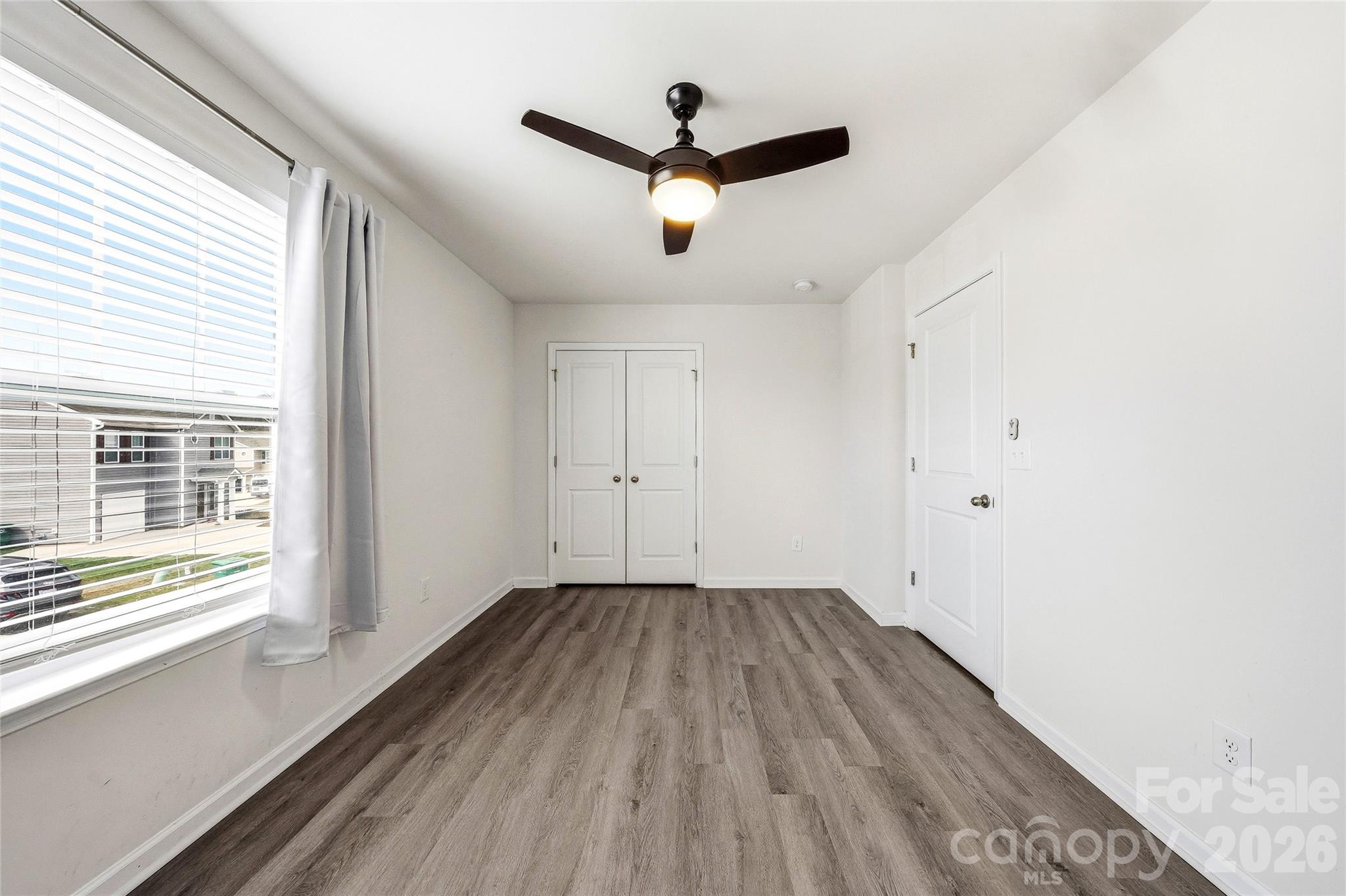 319 Oak Br Road Arden, NC 28704 - Photo 28 of 33 a view of empty room with wooden floor and fan