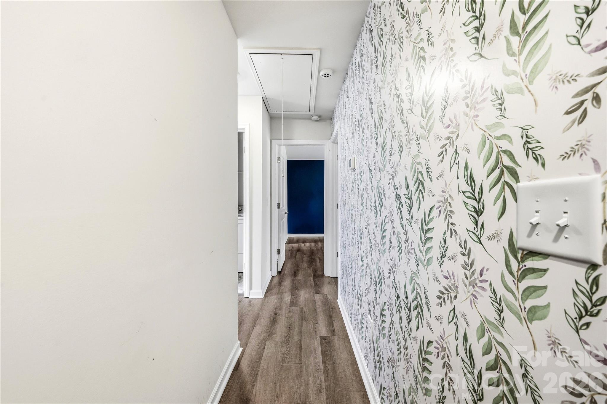 319 Oak Br Road Arden, NC 28704 - Photo 29 of 33 a view of a hallway with wooden floor and a painted wall