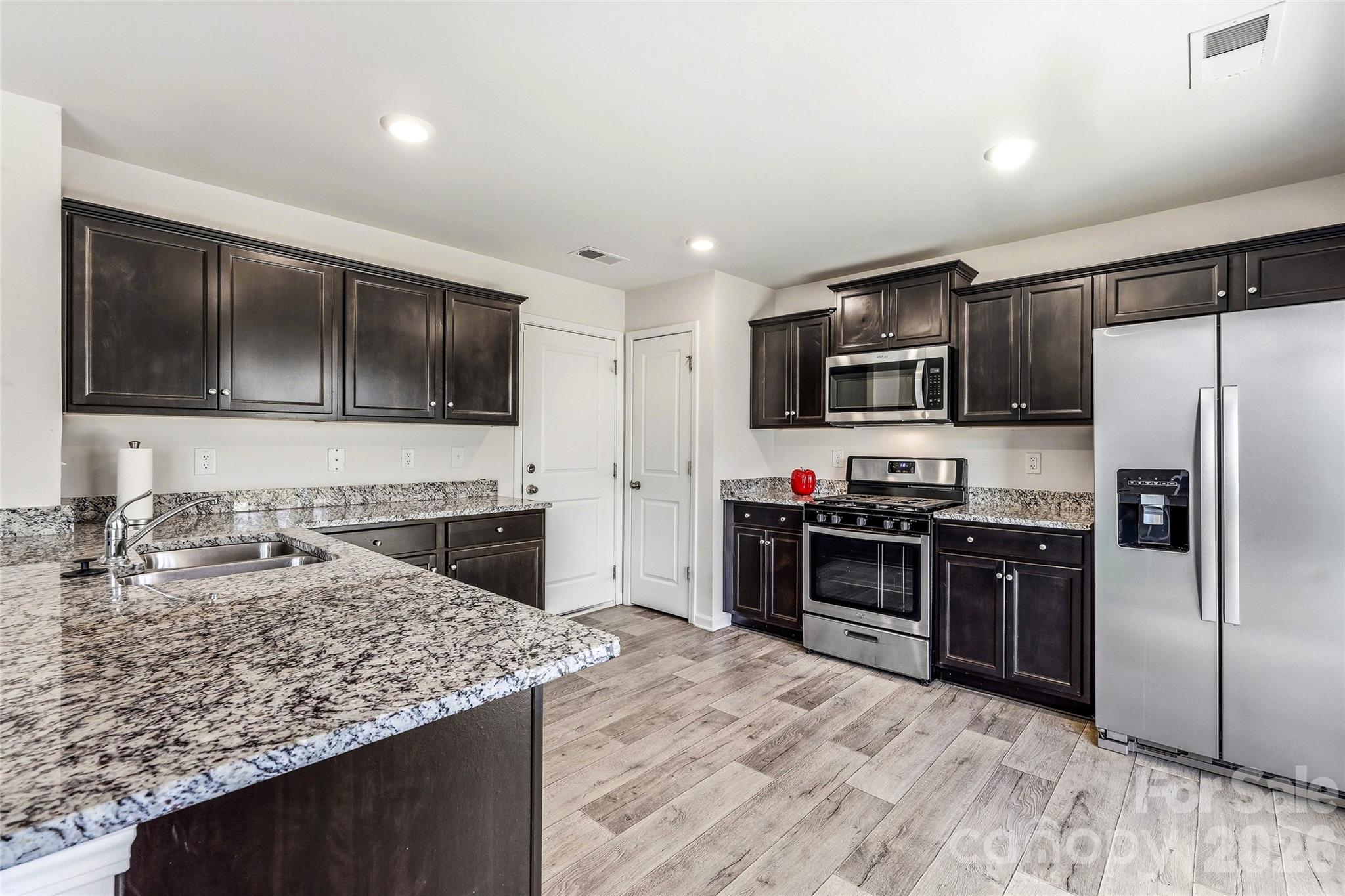 319 Oak Br Road Arden, NC 28704 - Photo 3 of 33 a kitchen with stainless steel appliances granite countertop a stove refrigerator and microwave