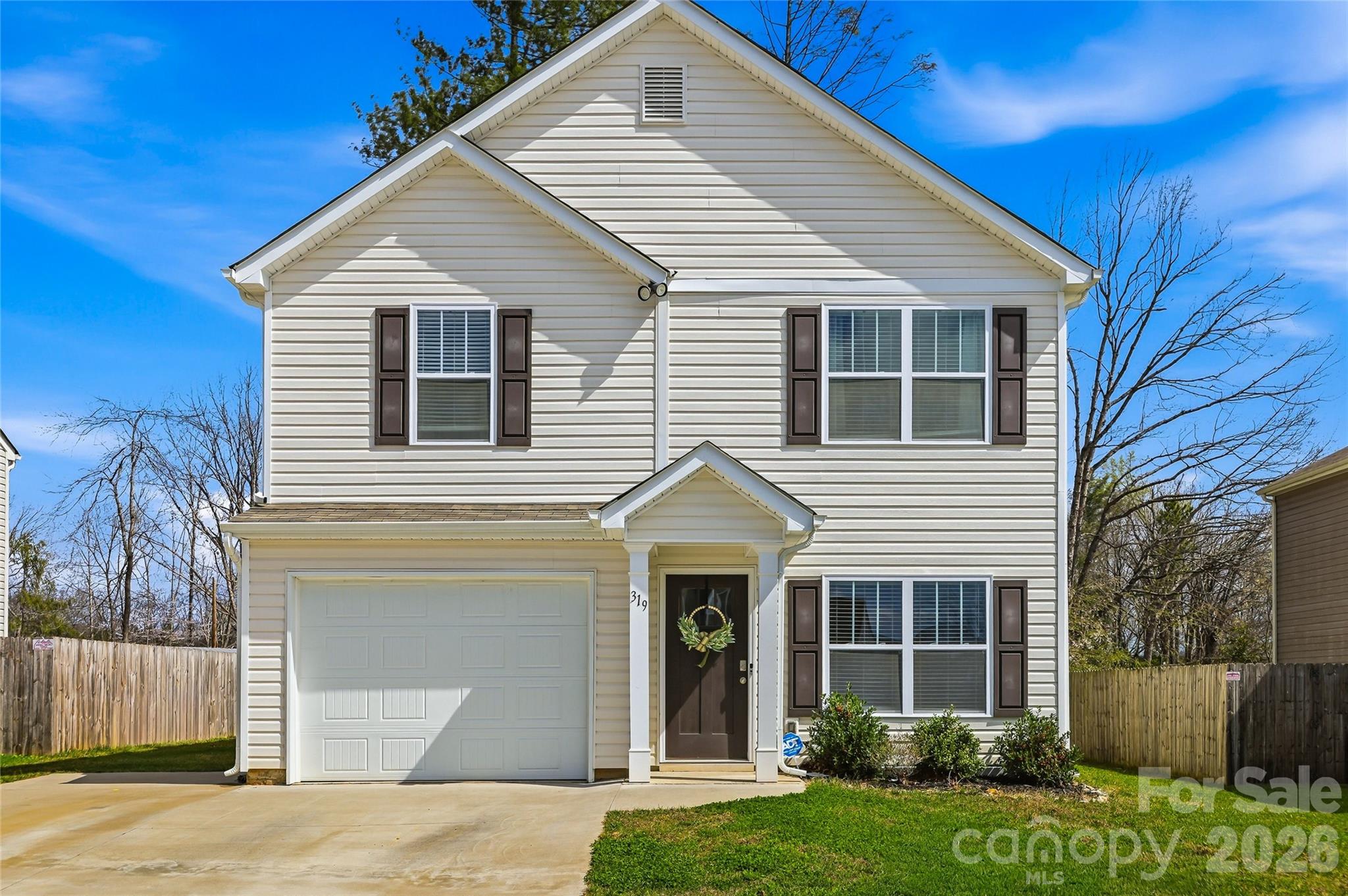 319 Oak Br Road Arden, NC 28704 - Photo 6 of 33 a view of a white house with a small yard and large tree
