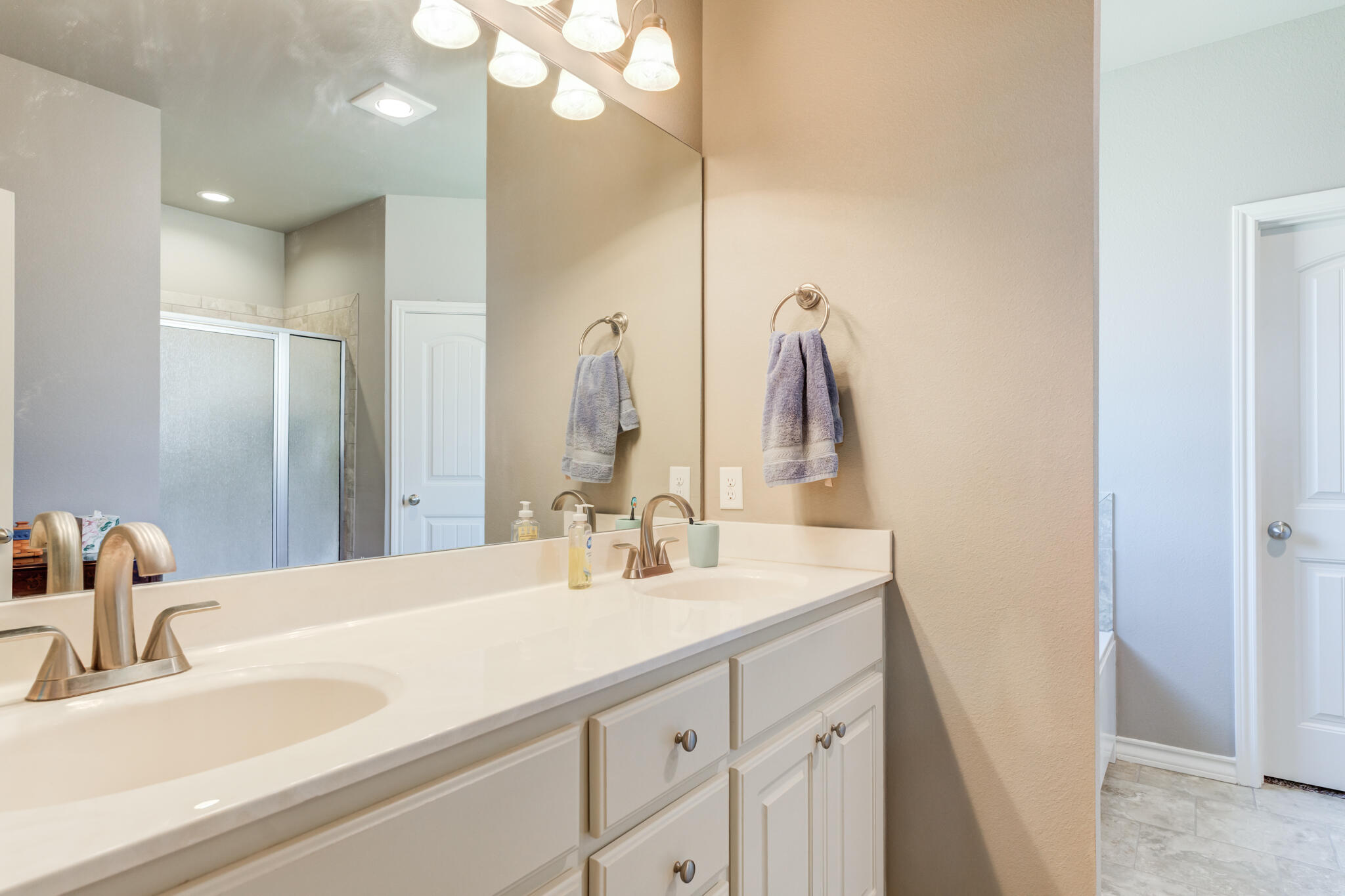 5219 Kemper Street Lubbock, TX 79416 - Photo 24 of 38 a bathroom with double vanity sink and a mirror