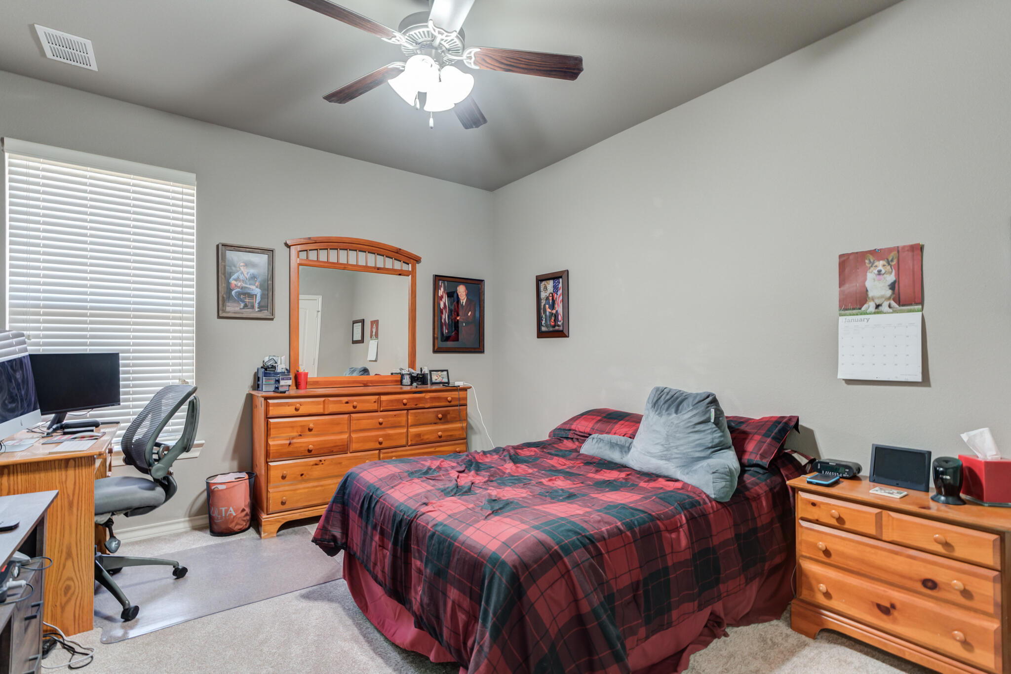 5219 Kemper Street Lubbock, TX 79416 - Photo 27 of 38 a bedroom with a bed and a flat screen tv