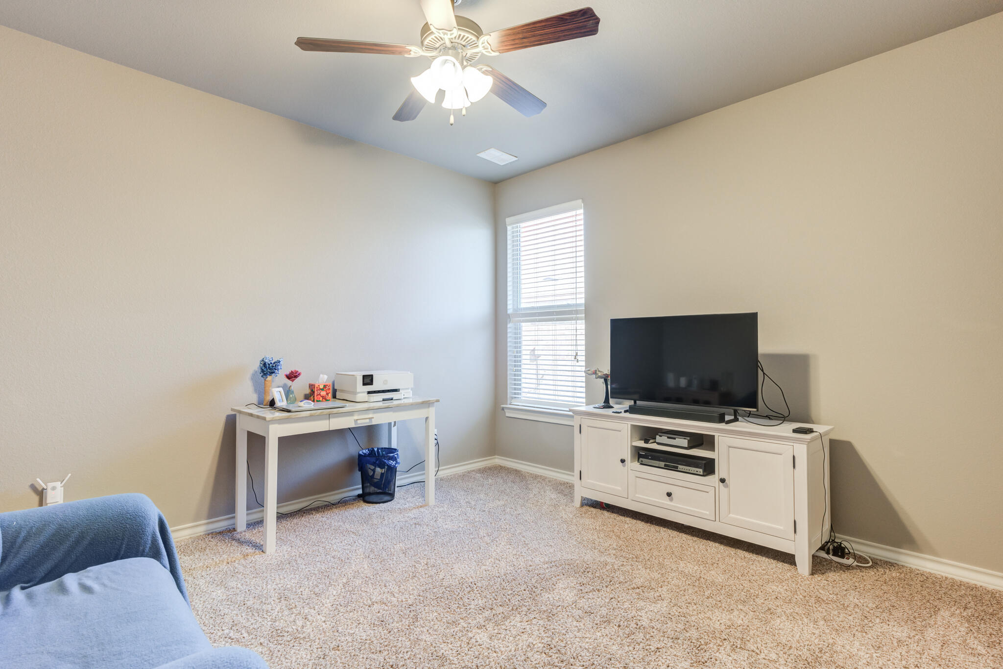 5219 Kemper Street Lubbock, TX 79416 - Photo 29 of 38 a living room with furniture and a flat screen tv