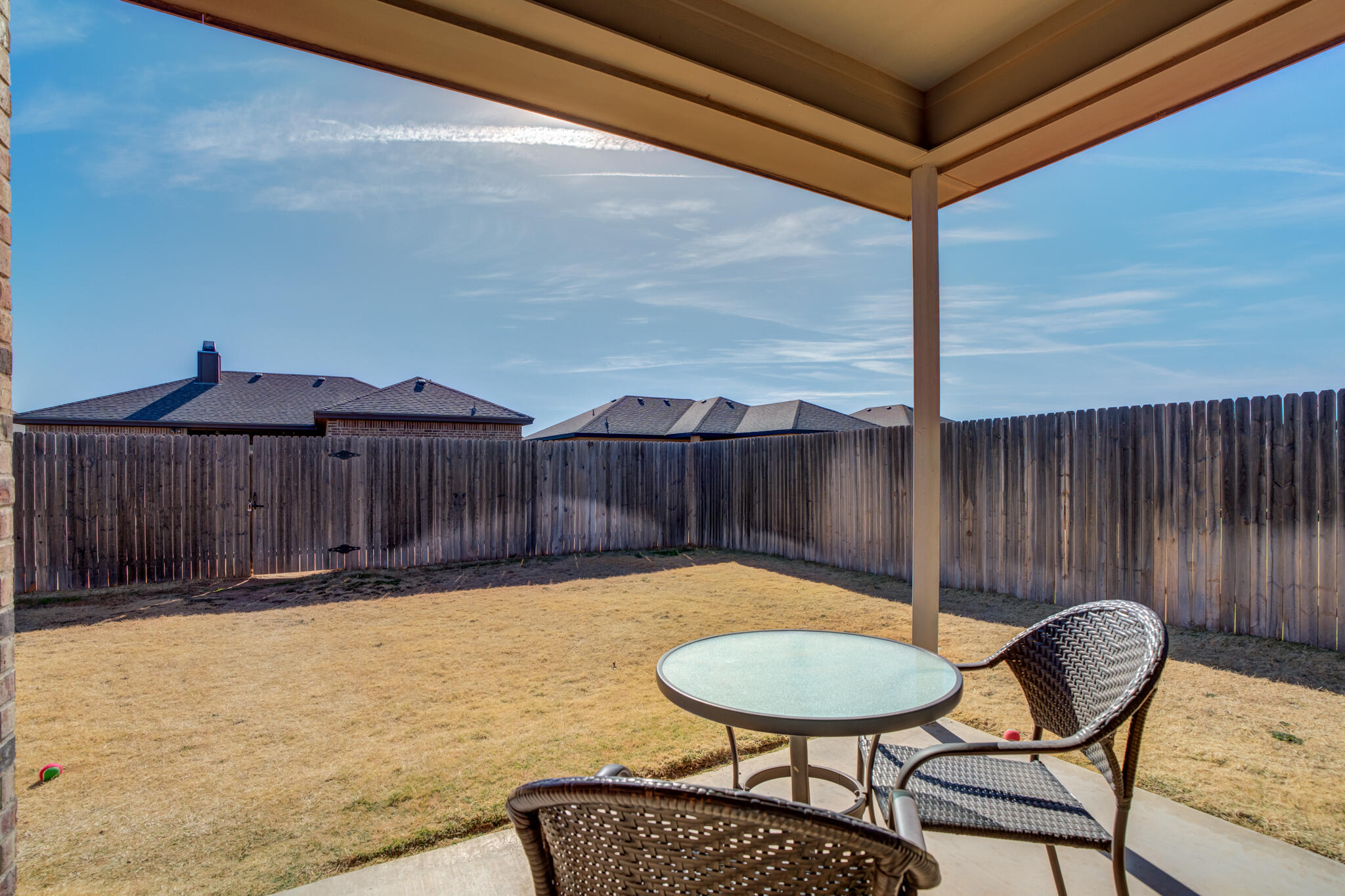 5219 Kemper Street Lubbock, TX 79416 - Photo 5 of 38 a view of a chairs and table in the patio