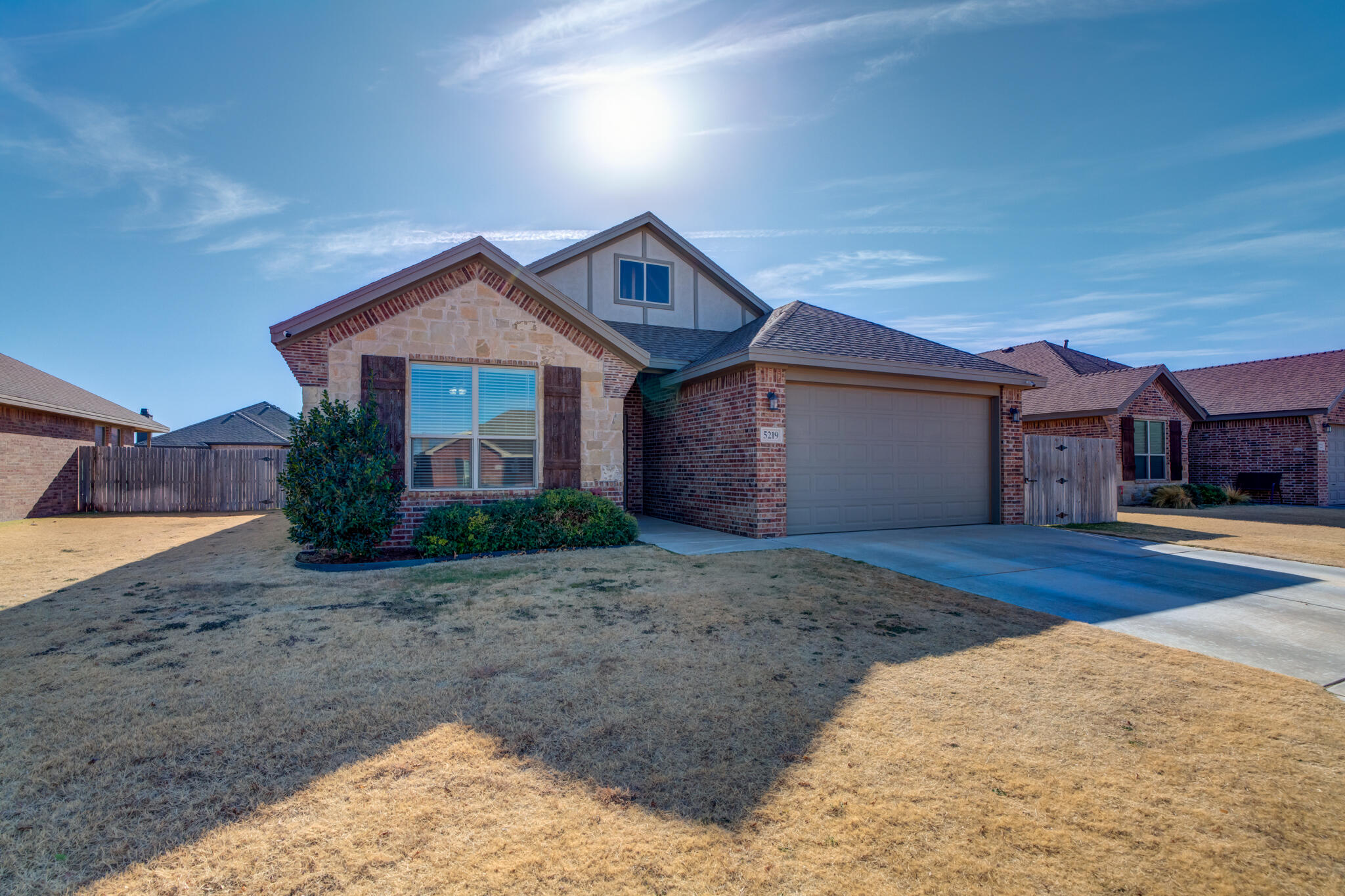 5219 Kemper Street Lubbock, TX 79416 - Photo 6 of 38 a front view of a house with a yard