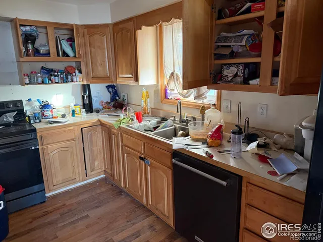 a kitchen with a sink cabinets and a window