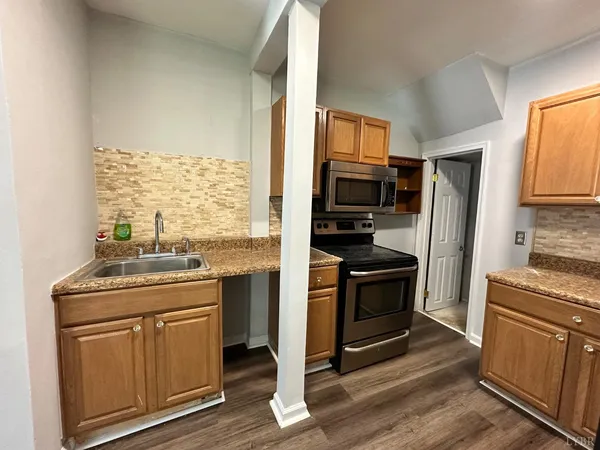 a kitchen with a stove a sink and a refrigerator