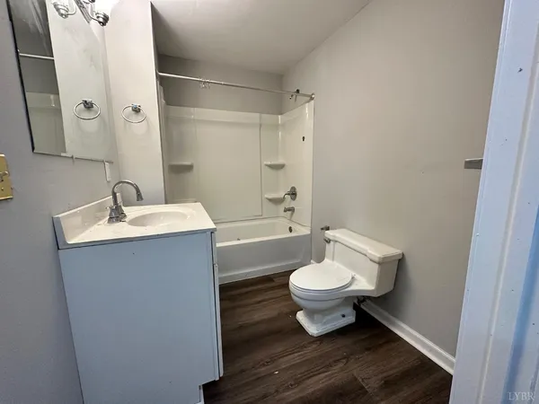 a bathroom with a sink toilet a mirror and shower