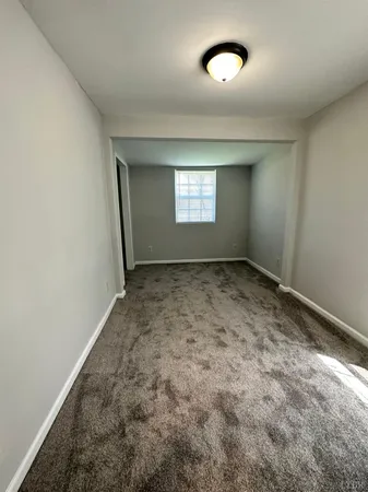an empty room with a empty space and windows